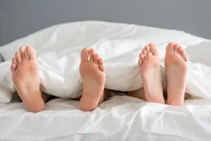 Feet resting on a bed