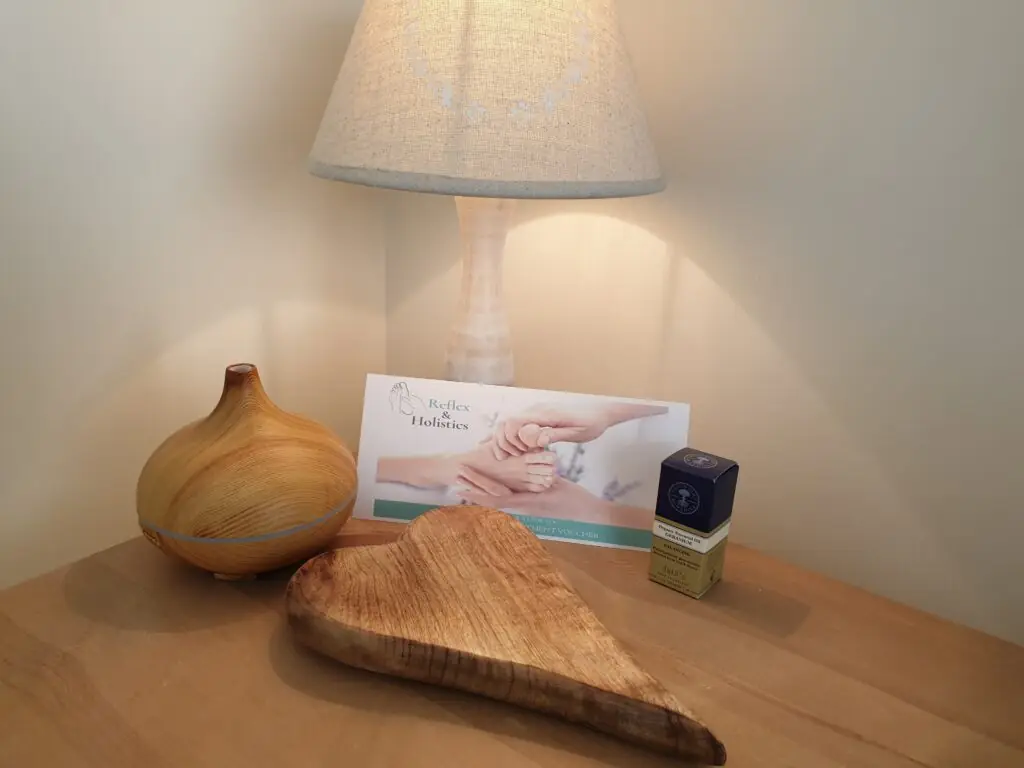 An essential oil bottle with a reflexology voucher